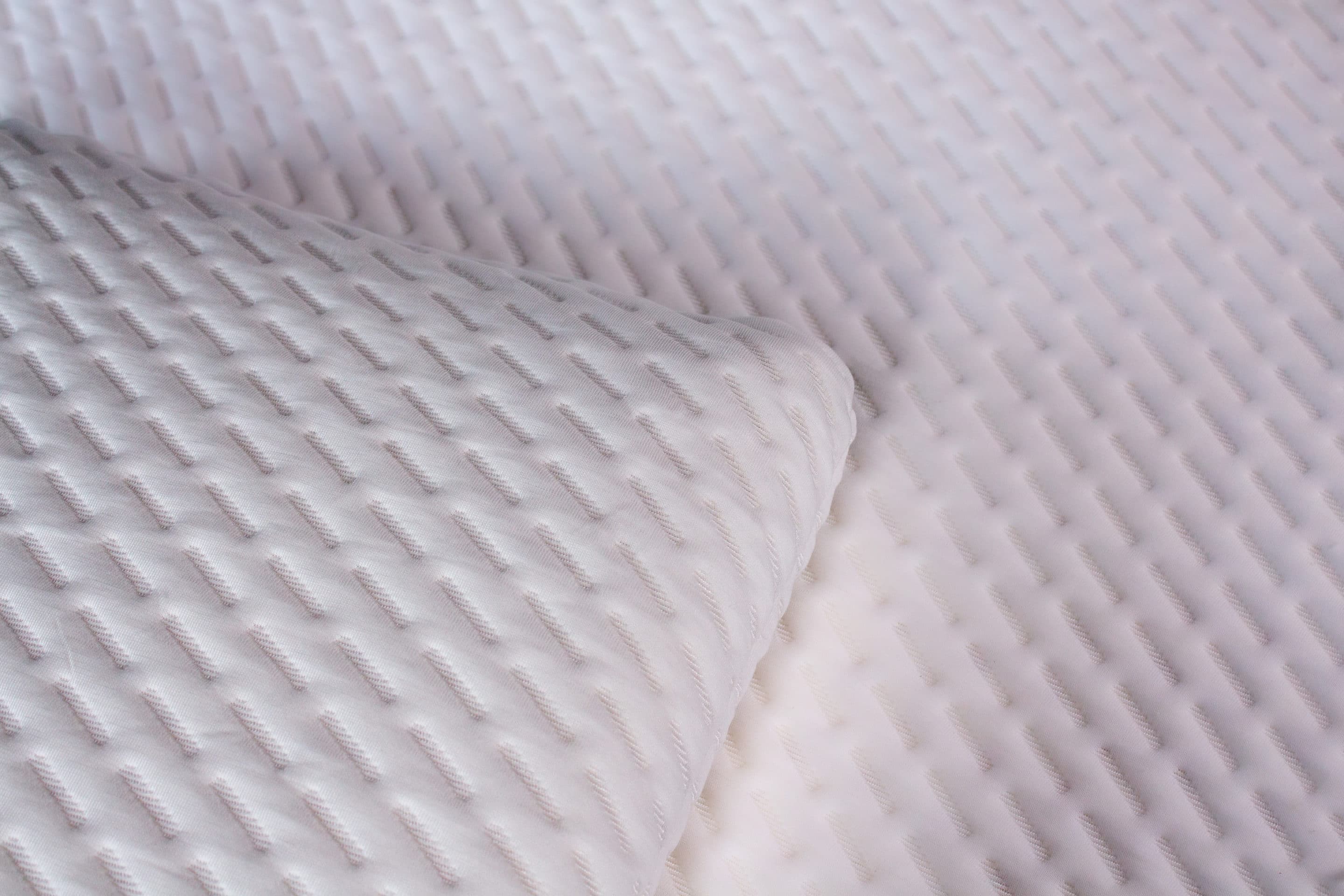 an image of natural latex pillow on a natural latex foam mattress with a white Tencel Cover