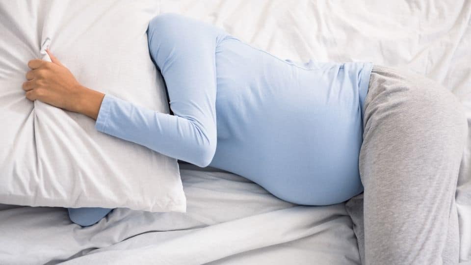pregnant woman sleeping on a comfortable mattress