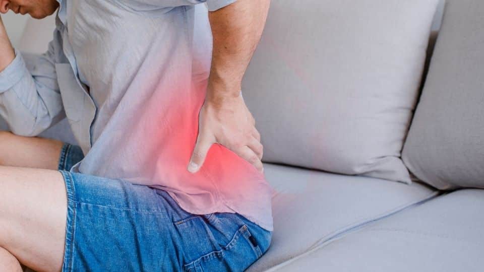 man suffering from back pain all day